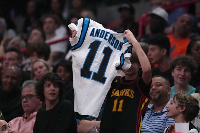 Apr 8, 2022; Miami, Florida, USA; A young fan catches a jersey from Carolina Panthers wide receiver Robbie Anderson who was in attendance during the second half of the game between the Miami Heat and the Atlanta Hawks at FTX Arena.